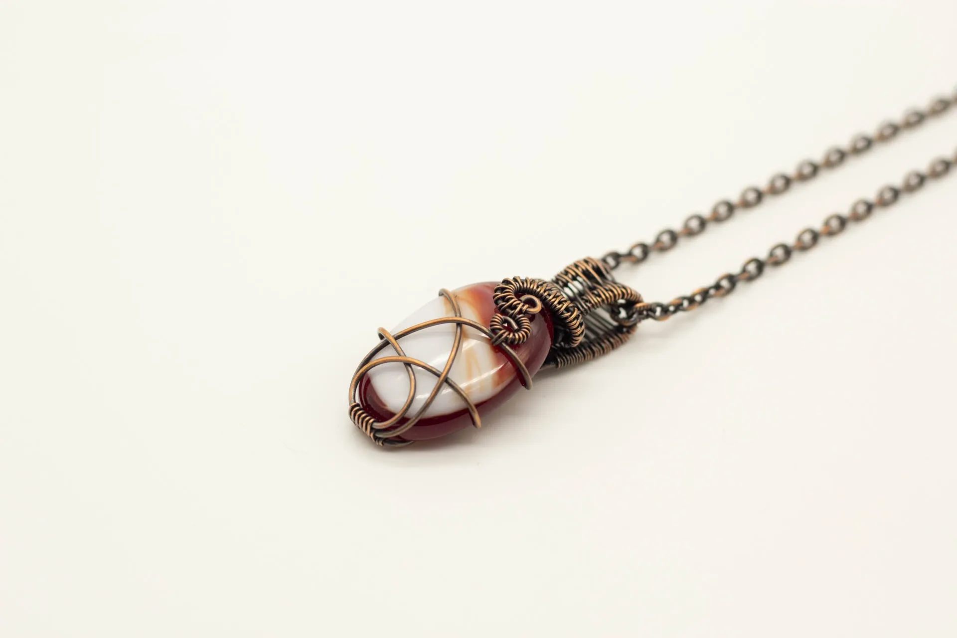 Streaked Red and White Oval Fused Glass Pendant with Copper Wire Wrapping