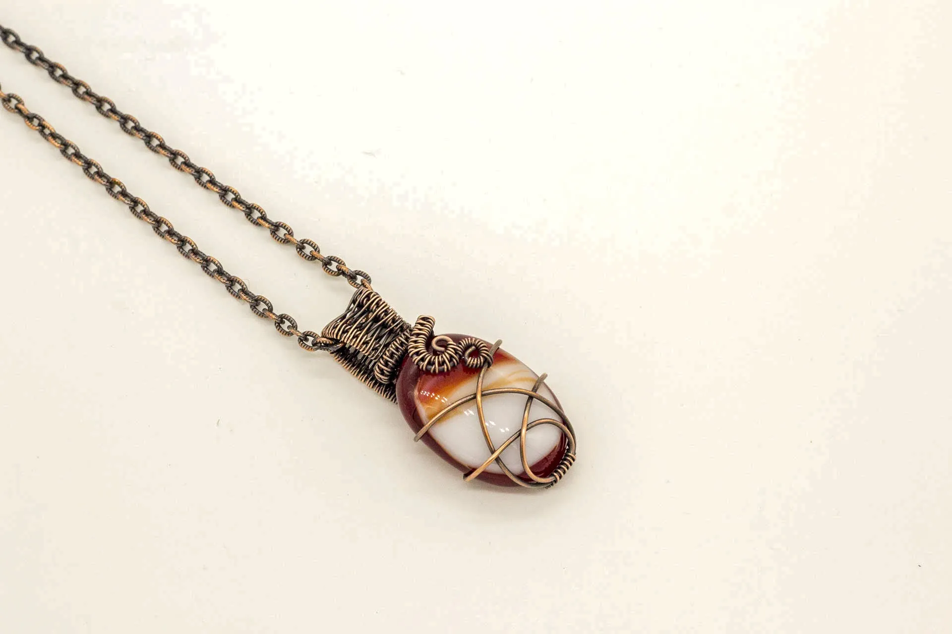 Streaked Red and White Oval Fused Glass Pendant with Copper Wire Wrapping